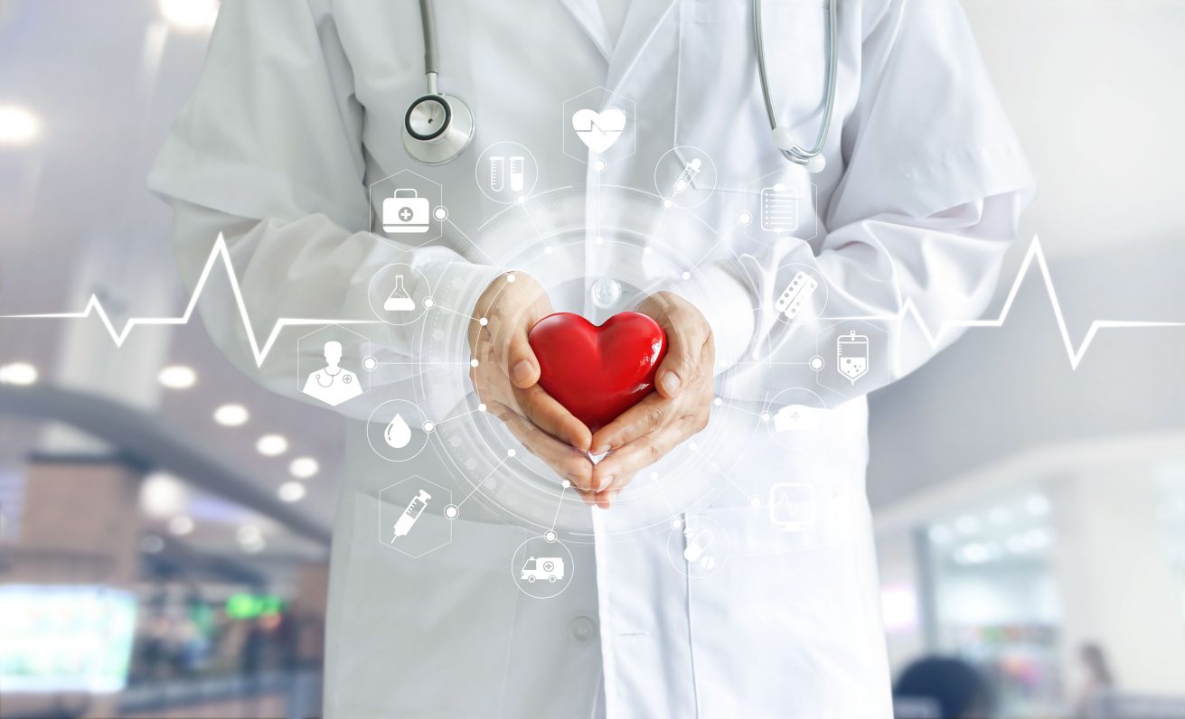 Medicine doctor holding red heart shape in hand and icon medical network connection with modern virtual screen interface, medical technology network concept Medicine doctor holding red heart shape in hand and icon medical network connection with modern virtual screen interface, medical technology network concept